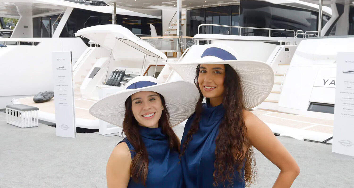 Beautiful women in stylish hats enjoying a sunny day at West Palm Beach marina.